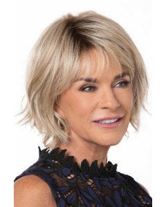 Woman in a past the chin light blonde bob wig with long layers and side bangs