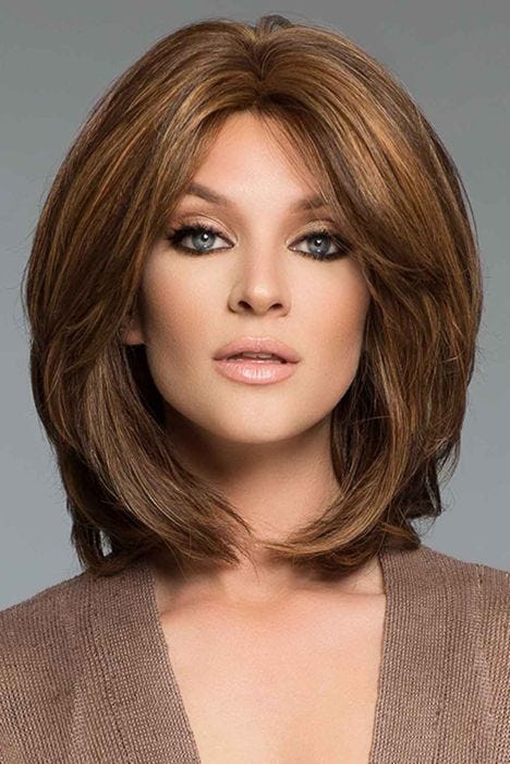 Woman in a shoulder length medium brown human hair wig with long layers