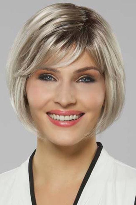 Woman in a platinum blonde chin length bob wig with a side part and side bangs
