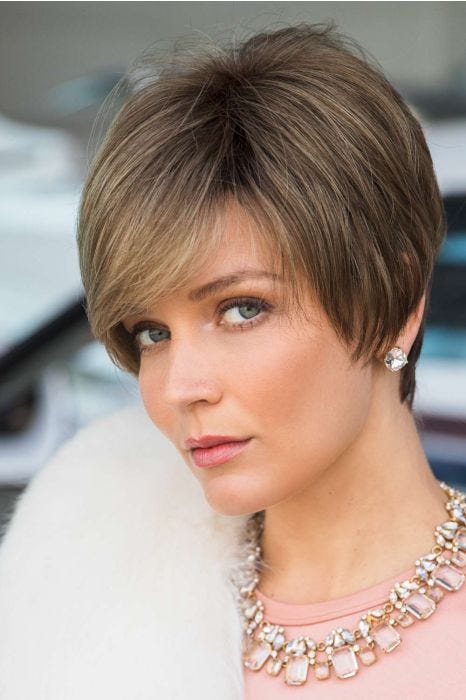 Woman in an extra long light brown pixie wig with side bangs
