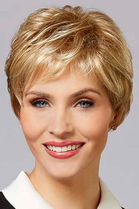 Woman in a close cropped classic pixie wig in light reddish blonde with short textured bangs