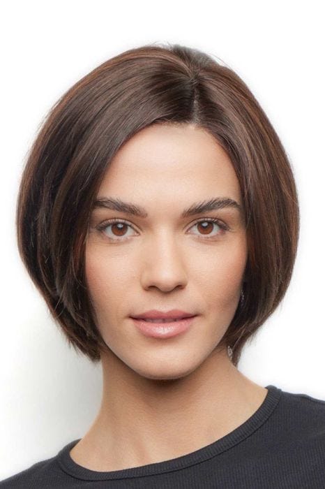 Woman in a human hair chin length dark brown rounded bob wig
