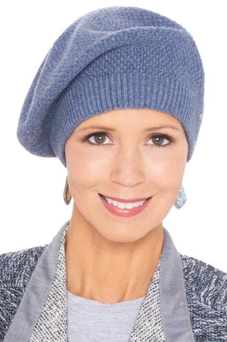 Woman in textured seed stitch winter beret hat for cancer patients