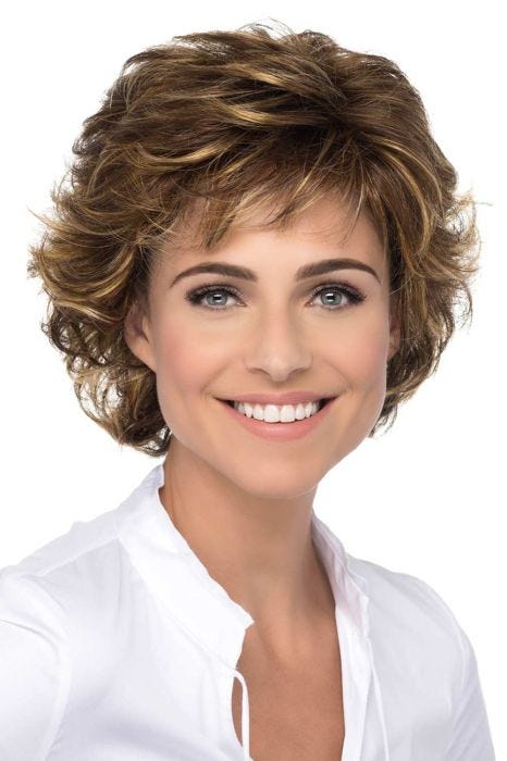 Woman in a chin length short medium brown wig with wispy bangs