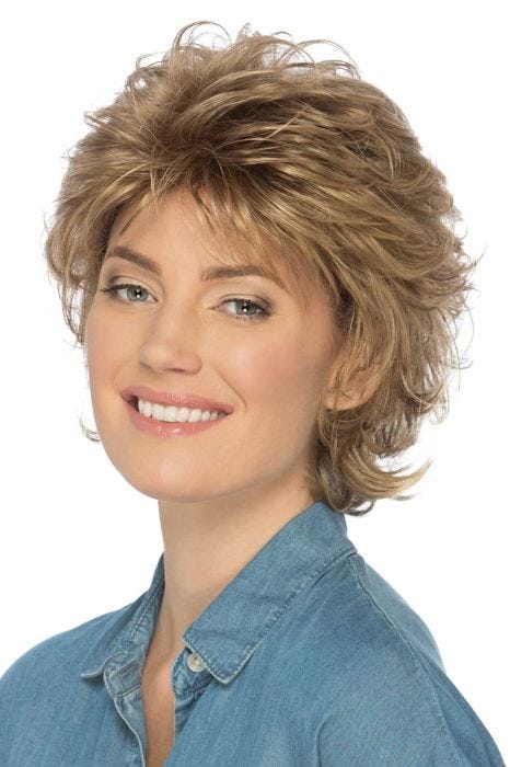 Woman in a volume infused short layered warm blonde wig