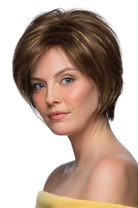 Woman in a chin length chestnut brown layered bob wig with side bangs