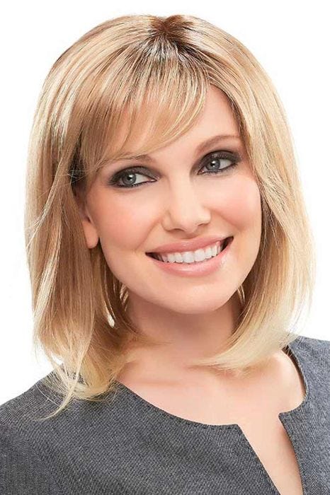 Woman in a shoulder length blonde blunt bob wig with side bangs