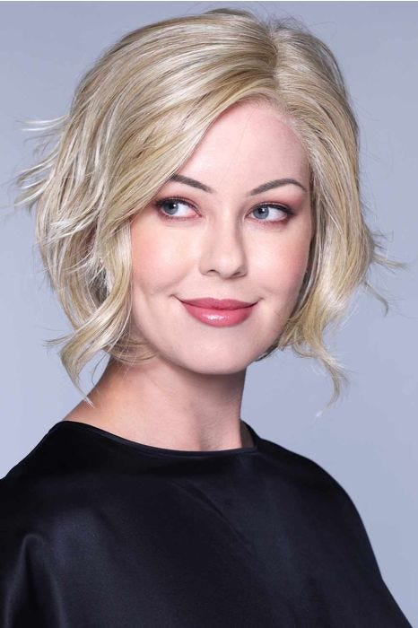 Woman in a shoulder length light blonde curly layered lace front bob wig