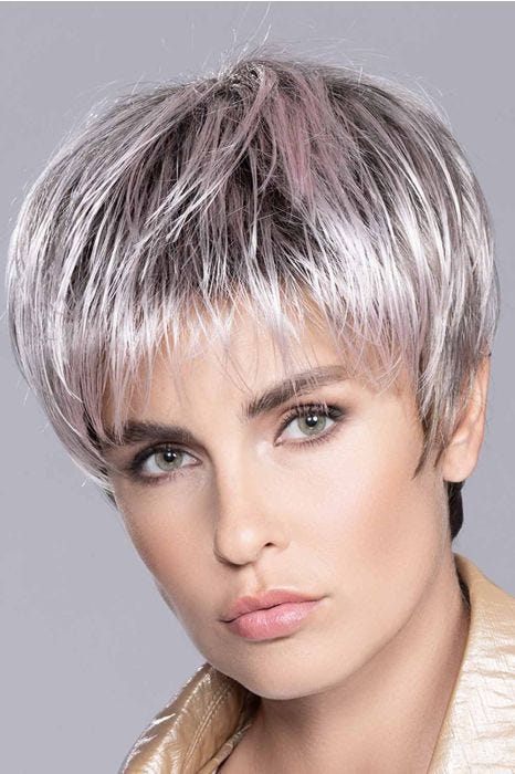 Woman in a brushed forward long grey and light pink pixie wig with dark roots