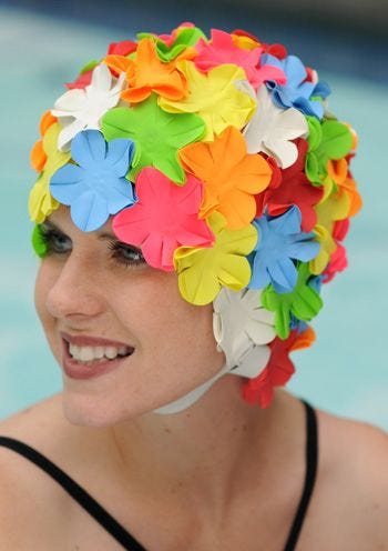 Woman in multicolored old fashioned style floral swimming cap with chin strap