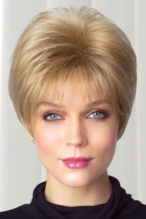 Woman in short, straight layered blonde wig with longer back, bangs and volume at crown