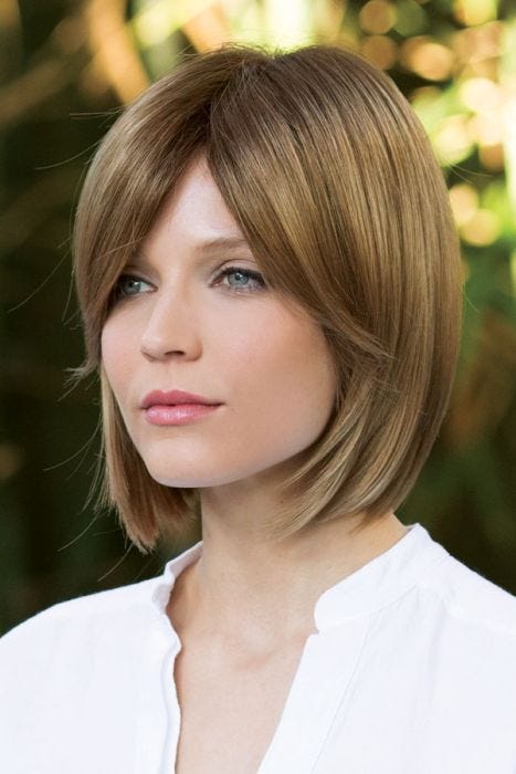 Woman in blonde straight bob wig with blunt cut and side bangs