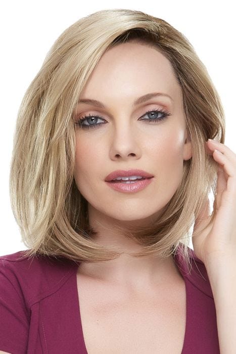 Woman in a shoulder length blonde blunt bob wig with long layers