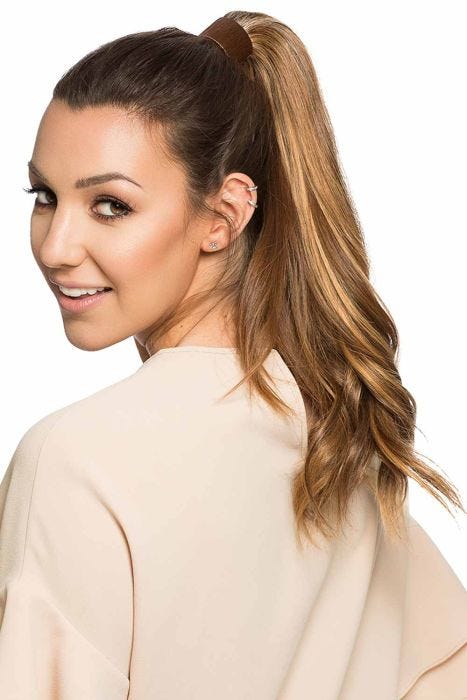 Woman in a 14" light brown curly human hair ponytail hair extension