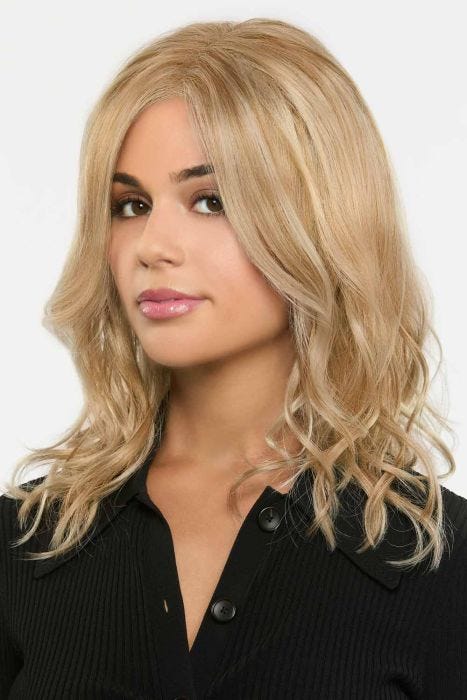 Woman in a past the shoulders warm blonde curly lace front wig