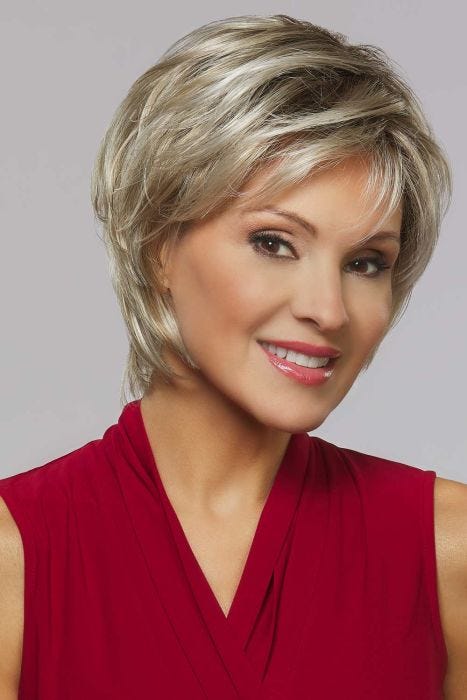 Woman in a close cropped ash blonde short lace front wig with wispy bangs