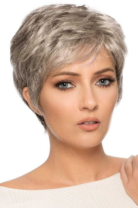 Woman in a light blonde classic pixie cut with short bangs