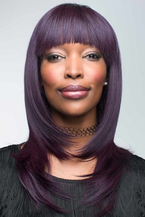 Afro American woman in a past the shoulders deep purple wig with face framing layers and angled bangs