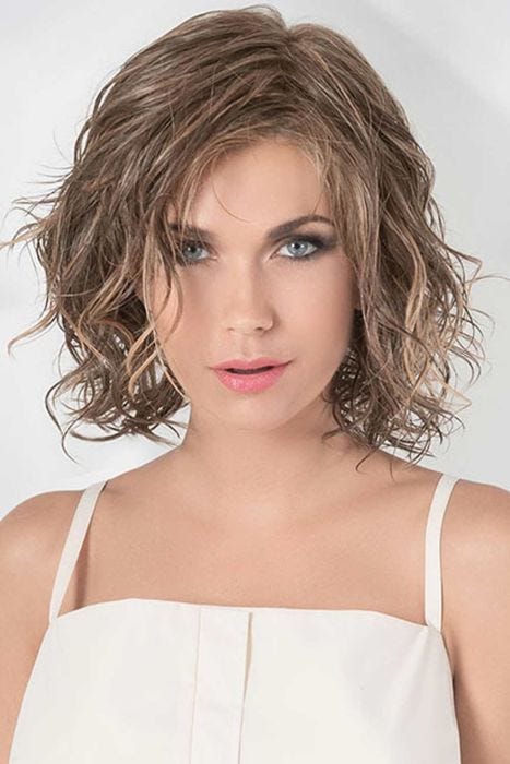 Woman in a shoulder length warm blonde lace front wig