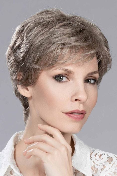 Woman in a long grey and brown lace front pixie wig