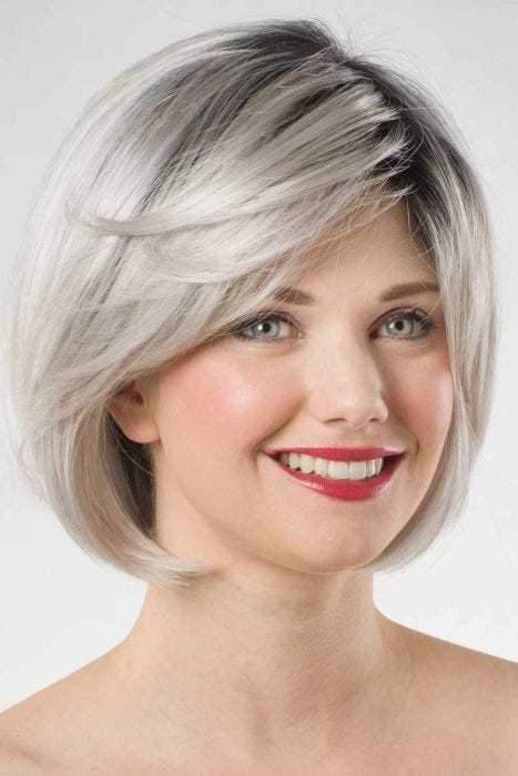 Woman in a past the chin silver rounded lace front bob wig with side bangs