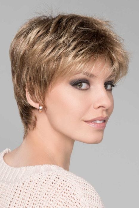 Woman in a classic light brown pixie wig with textured bangs