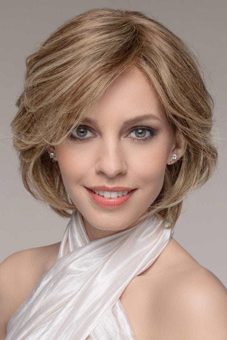 Woman in a long blonde chin length bob wig with long bangs and layers