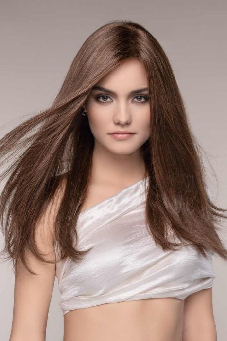 Woman in an extra long medium brown human hair lace front wig