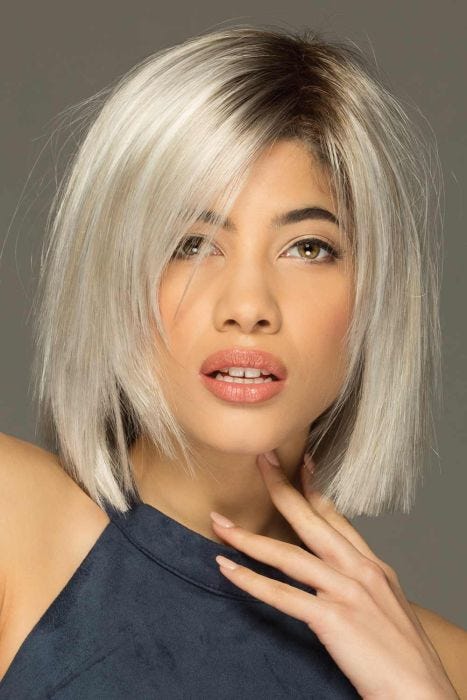 Woman in a shoulder length platinum blonde razor cut lace front wig