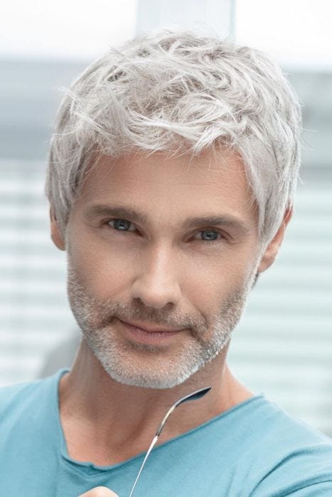 Man in a short tousled white lace front wig with longer hair on top