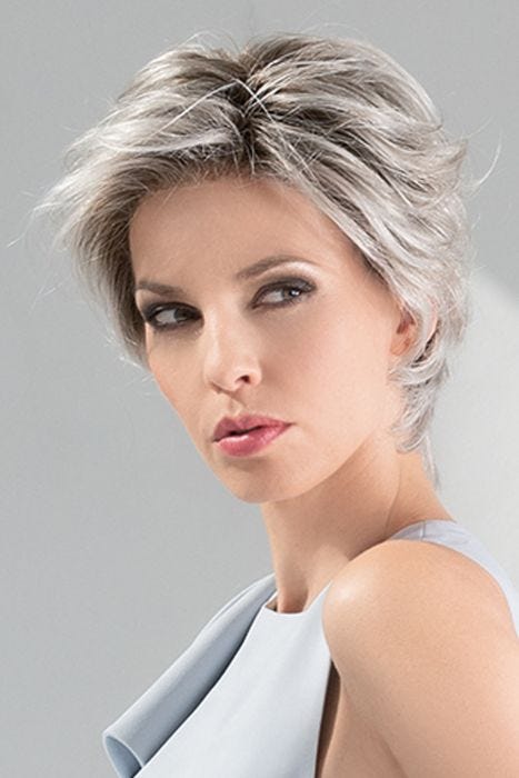 Woman in a long silver blonde lace front pixie wig