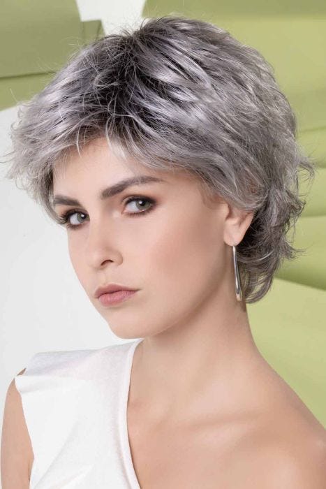 Woman in a long medium grey evenly layered lace front pixie wig