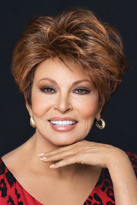 Raquel Welch in a medium auburn layered pixie wig with longer hair on top for added volume