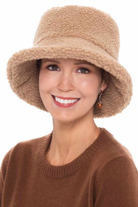 Woman in fluffy winter sherpa bucket hat