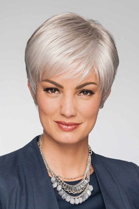 Woman in a light grey classic pixie wig with longer layers on top and side bangs