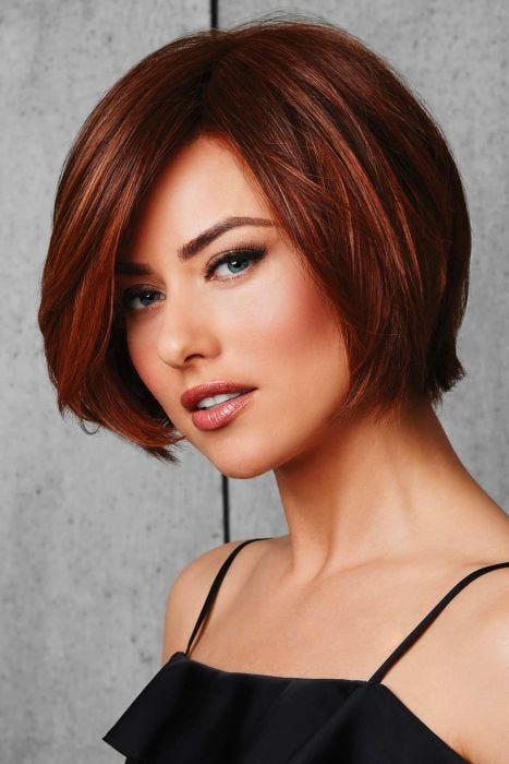 Woman in a chin length medium auburn rounded bob wig