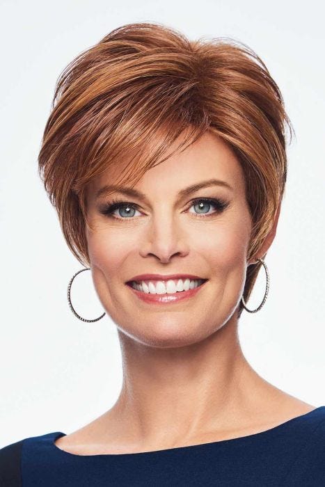 Woman in a medium auburn long pixie wig with side bangs