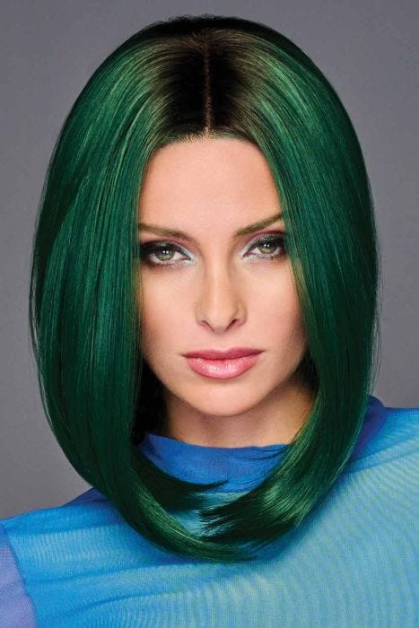 Woman in a past the shoulders angled straight emerald green wig