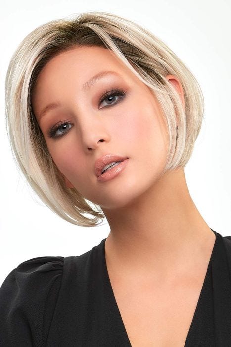 Woman in a petite chin length light blonde angled lace front wig