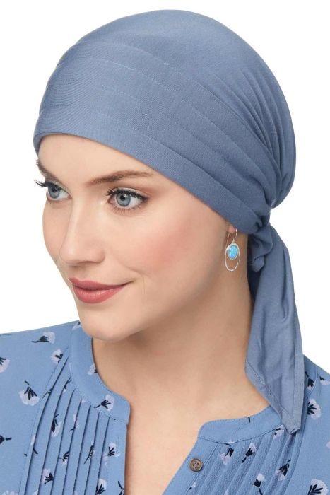 Woman in blue bamboo head covering for cancer patients with easy to tie padded scarf