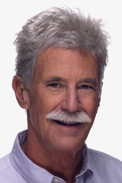 Older man in short, textured light grey toupee wig hairpiece