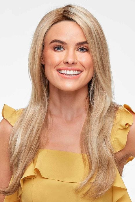 Woman in an extra long semi-wavy medium blonde lace front wig