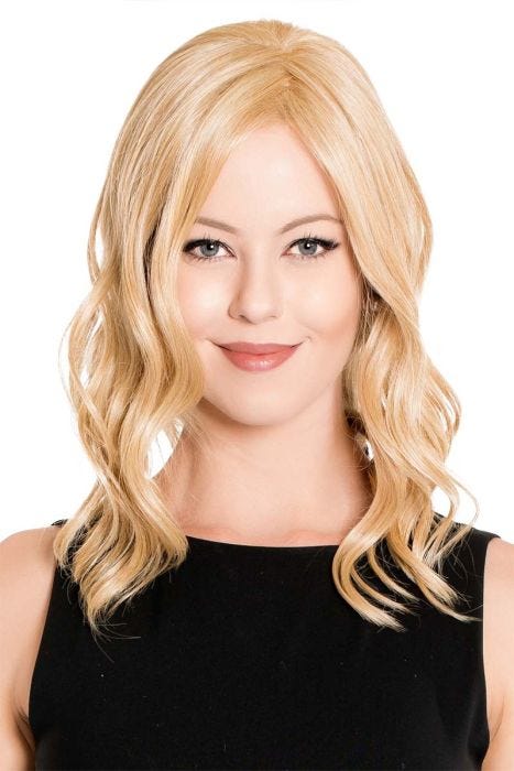 Woman in a 14" warm light blonde wavy hair topper blended with her hair