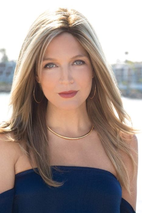 Woman with long blonde clip in hair topper in her hair