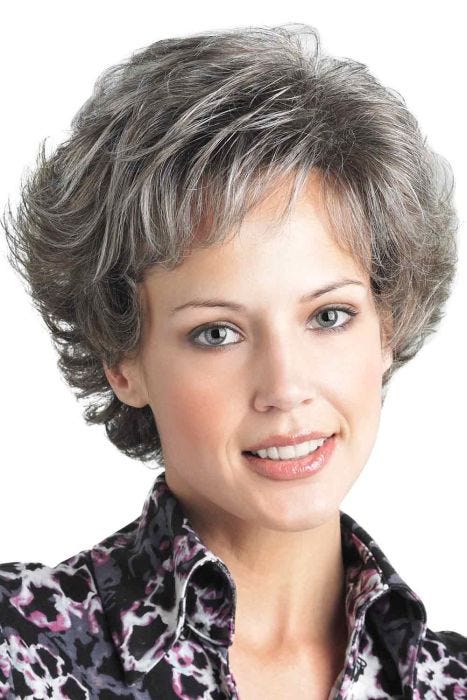 Woman in a petite short medium grey curly wig with short bangs