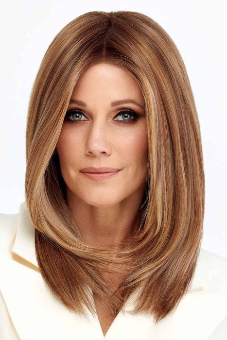 Woman in a past the shoulders light blonde straight lace front wig with long layers