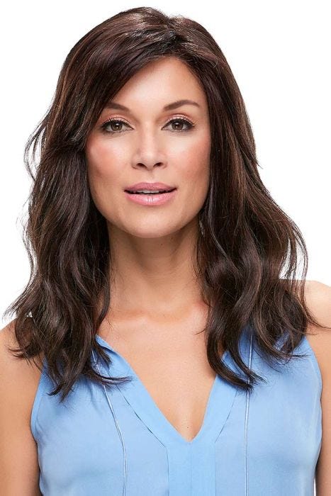 Woman in a past the shoulders dark brown wavy wig with long side bangs