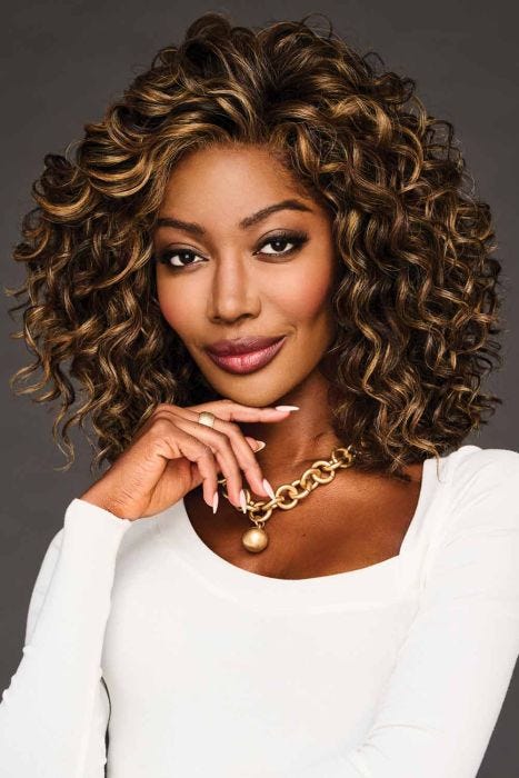 Black woman in a shoulder length ultra curly medium auburn wig