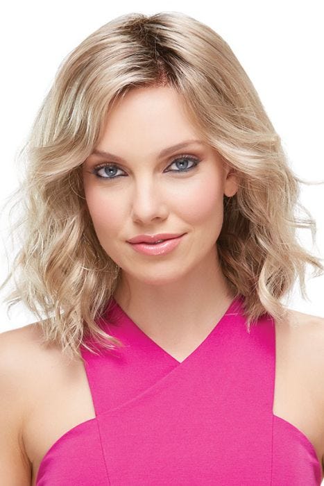 Woman in a petite shoulder length curly blonde lace front wig