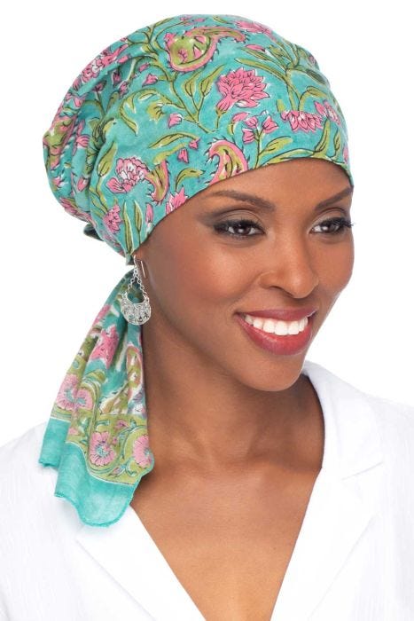 Women in teal floral pre tied cotton head scarf for women with cancer